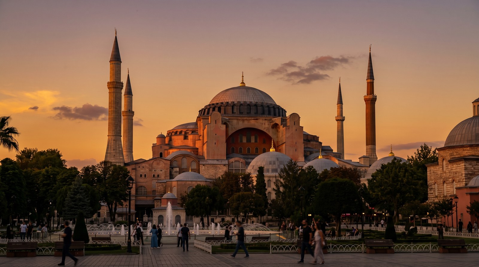 Hagia Sophia exterior at dusk with its great dome and minarets glowing gold over Sultanahmet, Istanbul